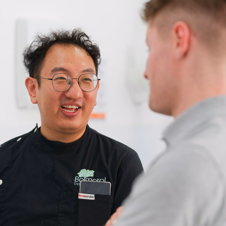 Balmoral Dental clinician smiling during a conversation with a patient